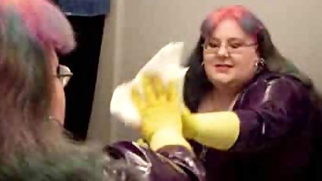 BBW in latex and gloves cleans the bathroom