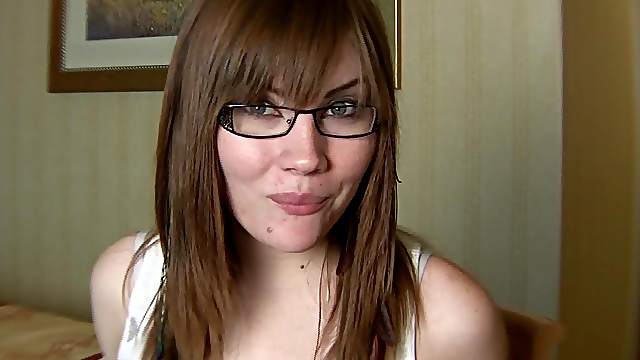 Sexy glasses on a gum chewing teen brunette
